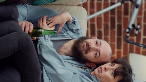 Friends on Couch Drinking Beer and Eating Chips