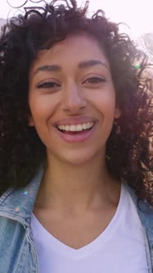 Closeup Portrait of Young Happy Woman Smiling at Camera Outdoors