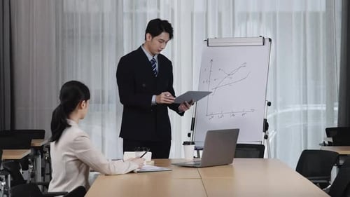 Young business group leader manager instructing staff on tasks, share solutions met in office board