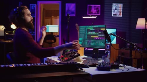 Male Musician Creating Digital Music in Home Studio