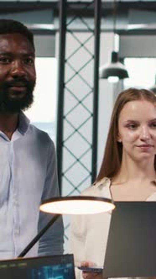 Vertical Video Portrait of Smiling Teamworking Programmers Utilizing AI to Optimize Performance