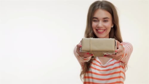 Smiling Woman Offering a Gift with Enthusiasm