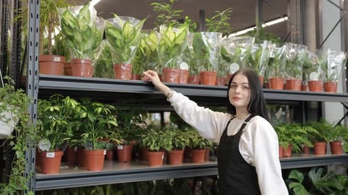 Young Female Florist Working in Garden Center