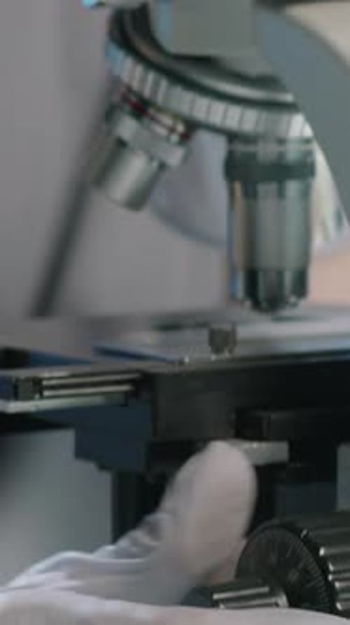 Scientist using a microscope in a lab