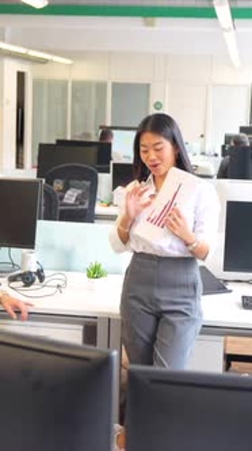 Confident Businesswoman Presenting Data in a Modern Office