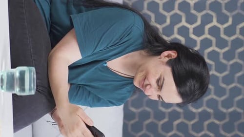 Smiling Woman Using Mobile Phone at Home