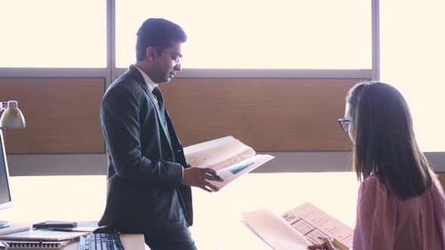 Business people in office meeting discussing paperwork and planning together