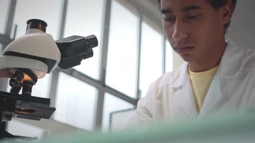 Scientist Using Microscope in Modern Laboratory