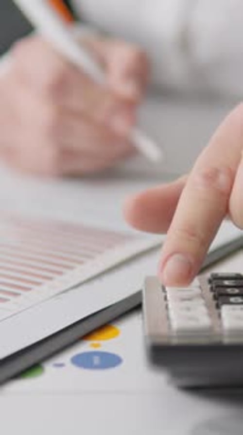 Close Up of Hand Calculating Finances on Chart
