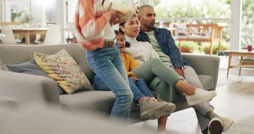 Family Relaxing Together on Couch at Home