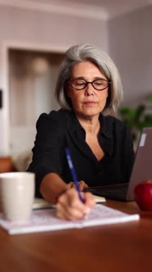 Senior Professor Working From Home on a Laptop
