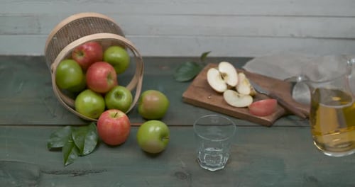 Pouring fresh apple juice next to apples