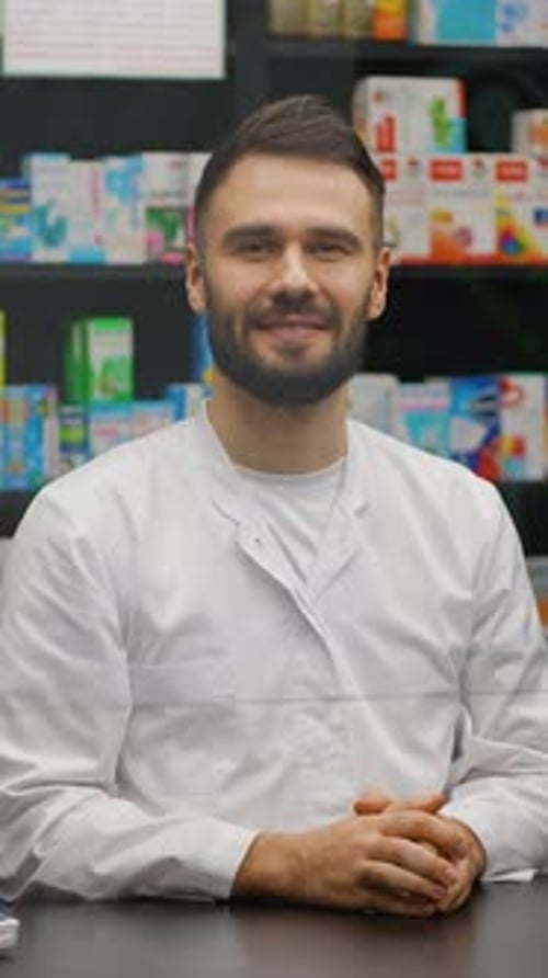 Professional Male Pharmacist Portrait at Pharmacy Counter