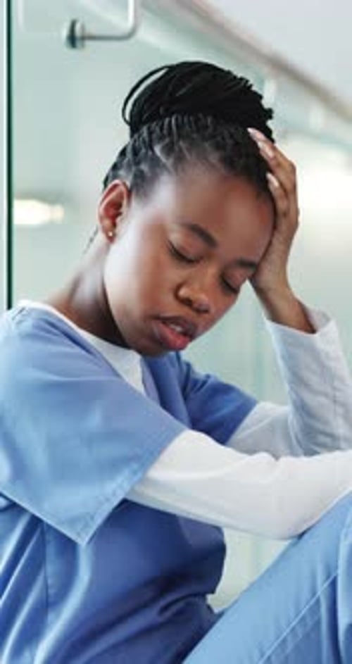Tired, black woman and nurse with stress in hospital for medical mistake
