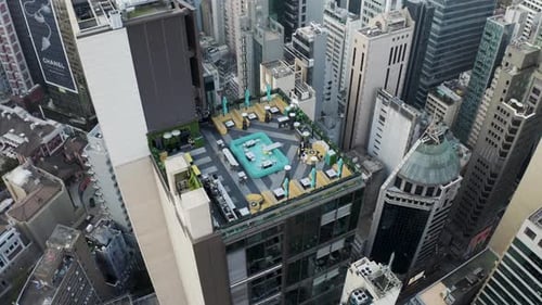 Aerial view of Hong Kong rooftop bar and skyline during sunset.