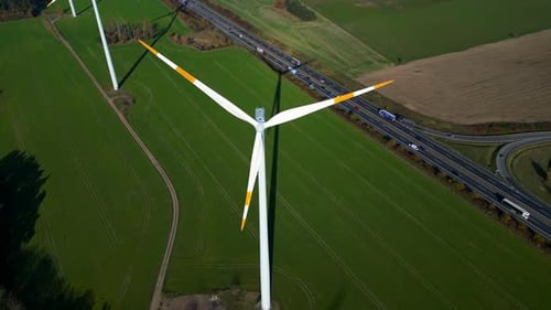 Wind farm Windmill turbines near highway clean energy. Magic aerial view flight drone