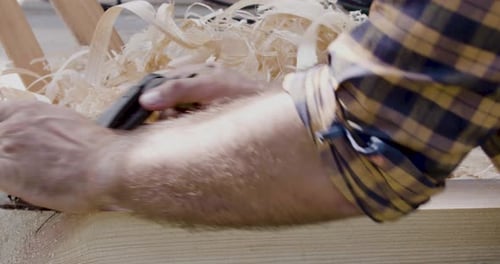 Man Smoothing Wood with a Hand Plane