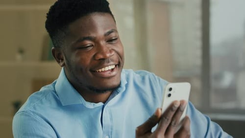 Smiling Man Video Chatting on Smartphone
