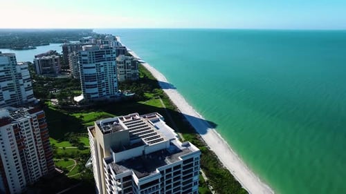 Naples Florida waterfront homes and golf courses seen from above in aerial drone shot