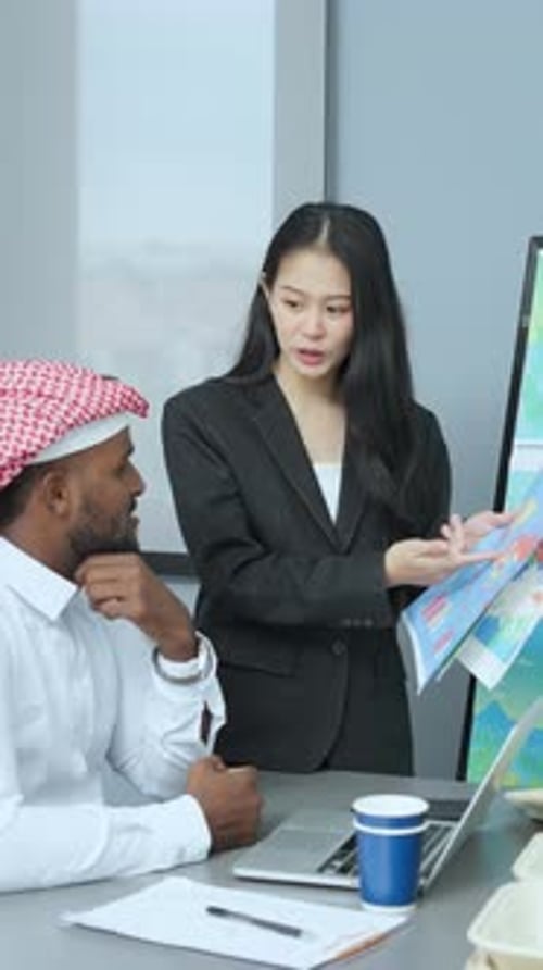 Asian businesswoman discussion over financial charts