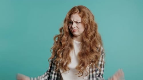 Woman Shrugging with Palms Up in Studio