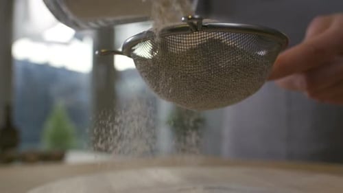 Sieving Flour Preparation on Wooden Table Indoors