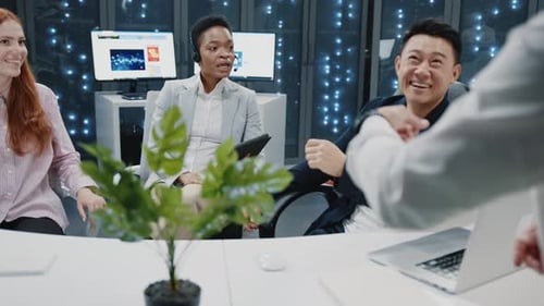 Multiethnic Staff of IT Workers Cooperating in Cyber Office Discussing Future Plans and Server