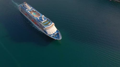 The Drone Captures a Stunning Aerial View of a White Cruise Ship Leaving the BokaKotor Bay in