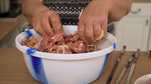 Mixing Pork Pieces with Onion and Spices in Bowl for Kebab Marinating Raw Meat with Seasoning and