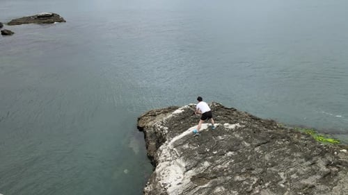 aerial man exercise on rock