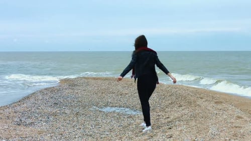 Young Woman Walking on Sandy Beach Enjoying Sea Wave and Splash Back