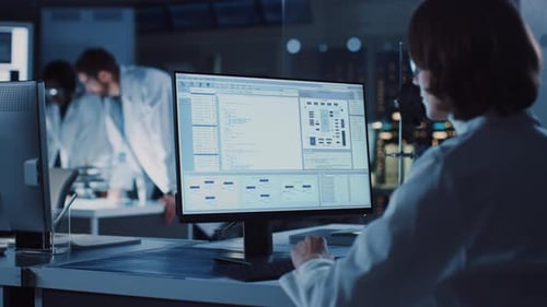 Scientists Working With Computers In a Research Laboratory