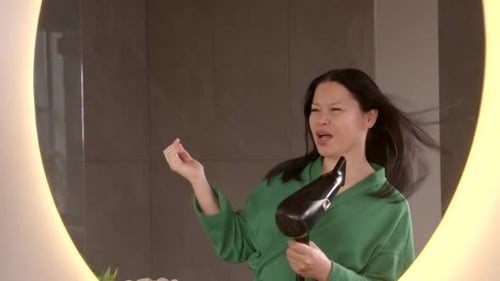 Woman Blow Drying and Singing in Bathroom