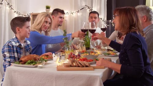 Family Gathering Around Festive Dinner Table Toasting Wine