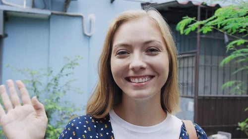 Portrait of Beautiful Tourist Girl Waving at Camera on Bangkok Asian Street