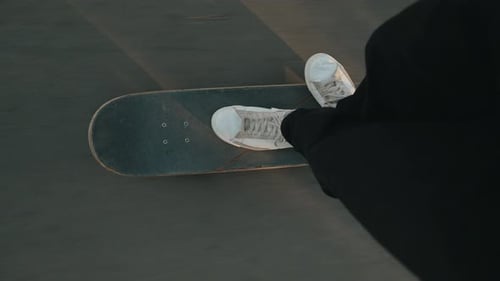POV Shot of Skateboarding Feet in White Sneakers Riding on Pavement