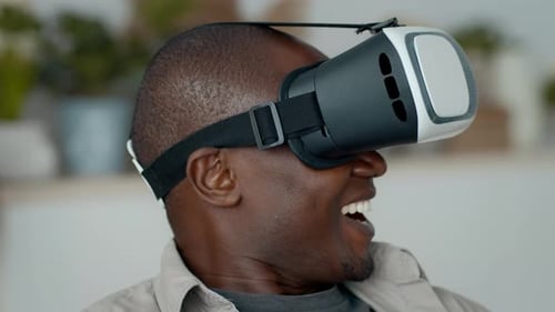 Man Wearing VR Headset Smiles in Home Setting