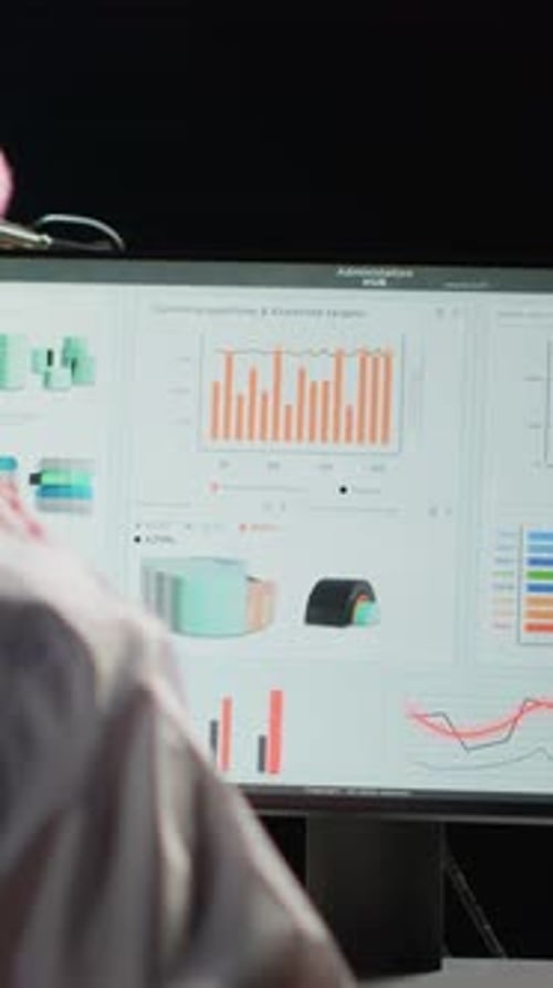 Man Reviews Business Data in Office