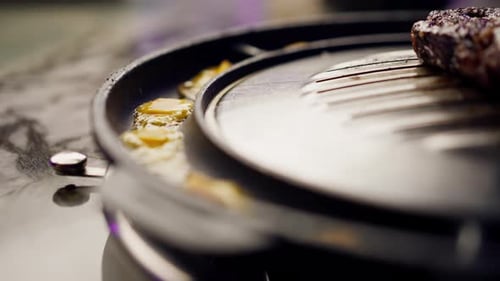 close up of delicious appetizing juicy piece of grilled meat with cheese being fried in restaurant