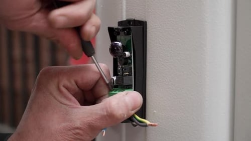 Electrical Panel Repair with Screwdriver and Wires