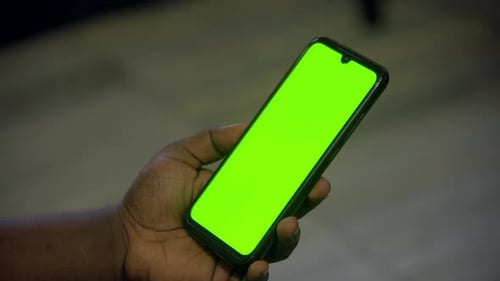 mobile green screen in man hand.
