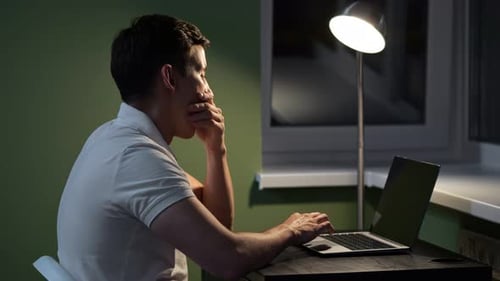 Man Working Late at Night on Laptop