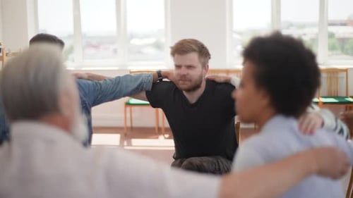 Closeup Selective Focus of Group of Diverse People Talking and Sitting in Circle During Group