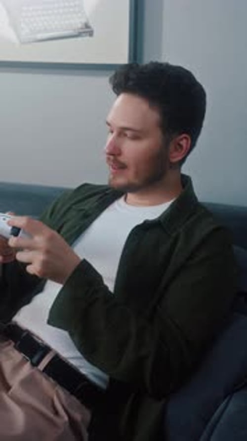 Man Relaxing on Sofa Playing Video Game