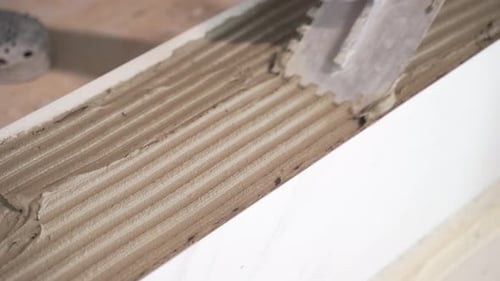 Hand Spreading Cement with Notched Trowel