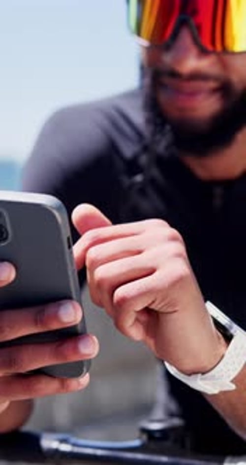 Cyclist, hands and man with phone outdoor for fitness app, track performance and cycling break