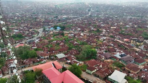 Aerial - Forward tilt-down shot of Ibadan metropolis with brown roof