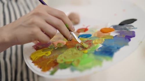 Artist Mixing Colors on Palette Closeup View in Art Workshop of Female Master Fine Art and Drawing