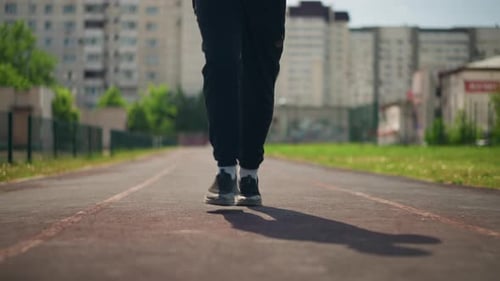 Person Runs on Track During Sunny Day Workout