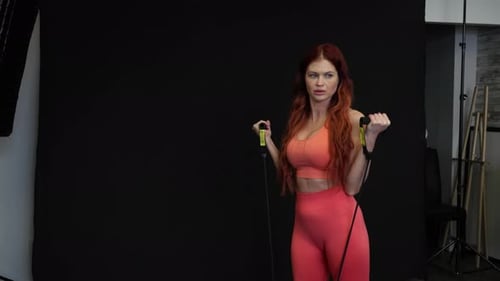 Young Adult Woman Exercising with Resistance Band